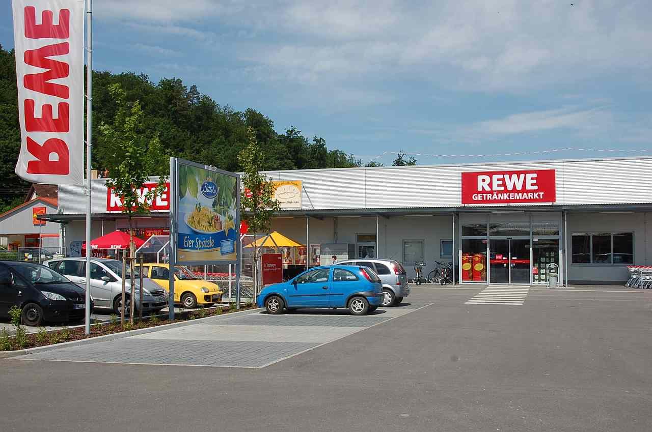Großfläche auf dem Parkplatz und in der Nähe zum Eingang eines REWE-Marktes Großfläche auf dem Parkplatz und in der Nähe zum Eingang eines REWE-Marktes